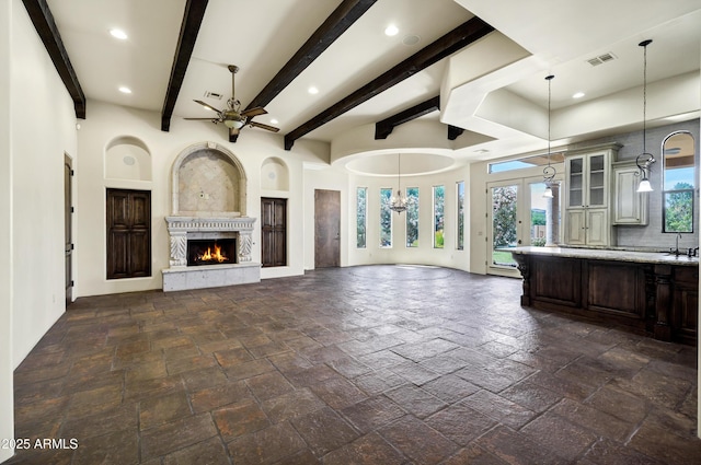 2300 E Sanoque Ct, Gilbert, AZ 85298 - unfurnished living room with ceiling fan, a fireplace, recessed lighting, stone tile flooring, and beam ceiling