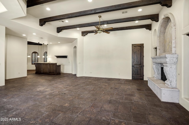 2300 E Sanoque Ct, Gilbert, AZ 85298 - unfurnished living room featuring arched walkways, recessed lighting, ceiling fan, stone tile flooring, and a premium fireplace