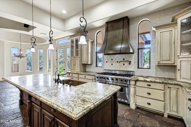 2300 E Sanoque Ct, Gilbert, AZ 85298 - kitchen featuring premium range hood, stainless steel stove, cream cabinetry, stone tile flooring, and recessed lighting