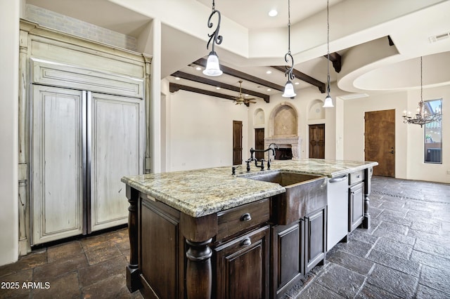 2300 E Sanoque Ct, Gilbert, AZ 85298 - kitchen with stone tile flooring, dishwashing machine, dark brown cabinetry, beamed ceiling, and a chandelier