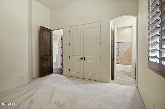 2300 E Sanoque Ct, Gilbert, AZ 85298 - unfurnished bedroom with arched walkways, light colored carpet, a closet, and ensuite bath