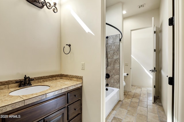 2300 E Sanoque Ct, Gilbert, AZ 85298 - full bath with stone tile flooring, toilet, vanity, and washtub / shower combination
