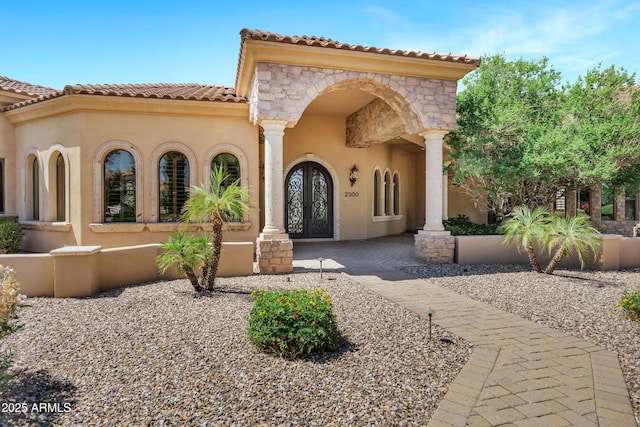 2300 E Sanoque Ct, Gilbert, AZ 85298 - mediterranean / spanish house with french doors, stucco siding, stone siding, and a tiled roof
