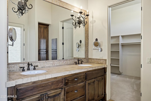 2300 E Sanoque Ct, Gilbert, AZ 85298 - bathroom with backsplash, double vanity, and a walk in closet