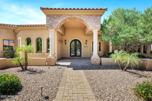 2300 E Sanoque Ct, Gilbert, AZ 85298 - doorway to property featuring french doors, stucco siding, stone siding, and a tiled roof