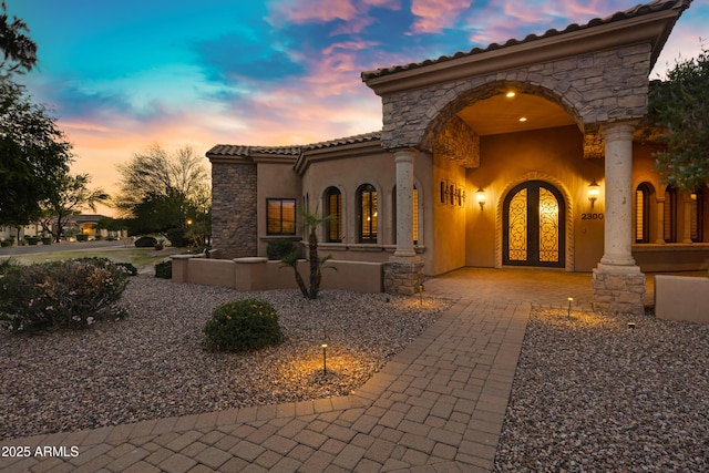 2300 E Sanoque Ct, Gilbert, AZ 85298 - view of front of property with a tile roof, stucco siding, stone siding, and french doors