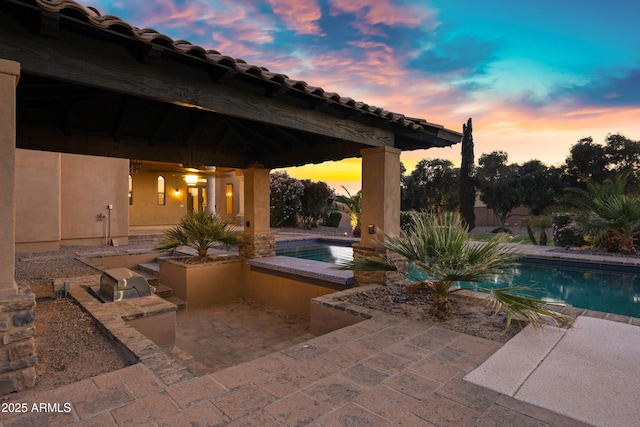 2300 E Sanoque Ct, Gilbert, AZ 85298 - pool at dusk featuring a patio area and an outdoor pool