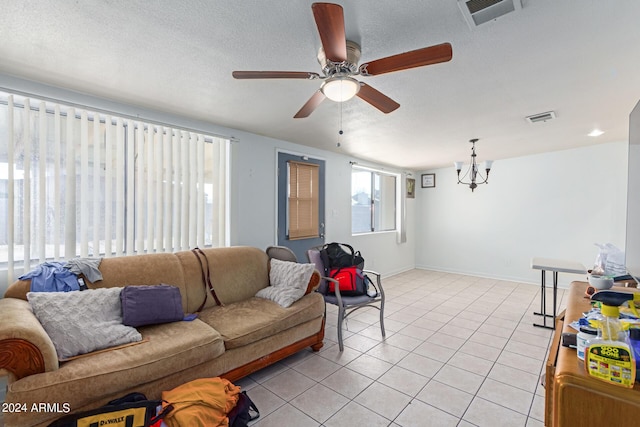 living room with visible vents, a textured ceiling, and light tile patterned flooring