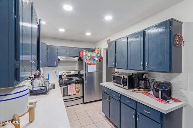 kitchen featuring light tile patterned floors, stainless steel appliances, light countertops, decorative backsplash, and under cabinet range hood