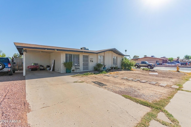 ranch-style house with a carport and concrete driveway