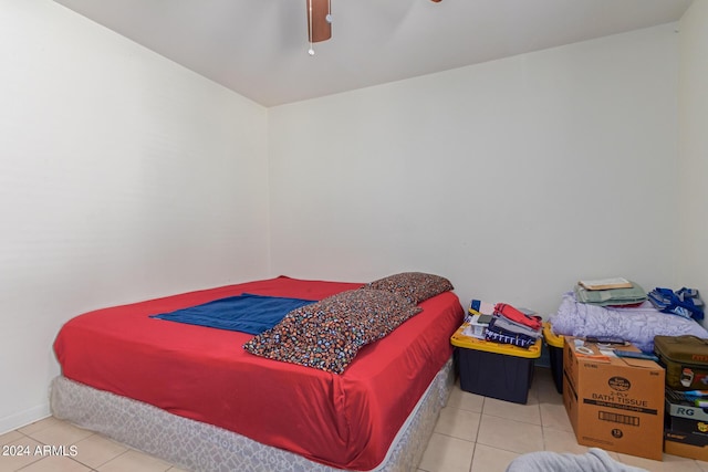 tiled bedroom featuring ceiling fan