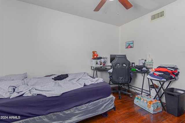 bedroom with hardwood / wood-style flooring, visible vents, and a ceiling fan