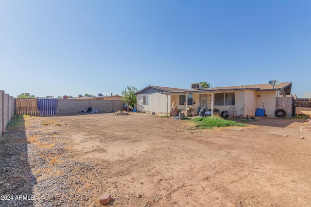 back of house with a fenced backyard