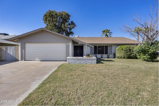 single story home with a front yard and a garage