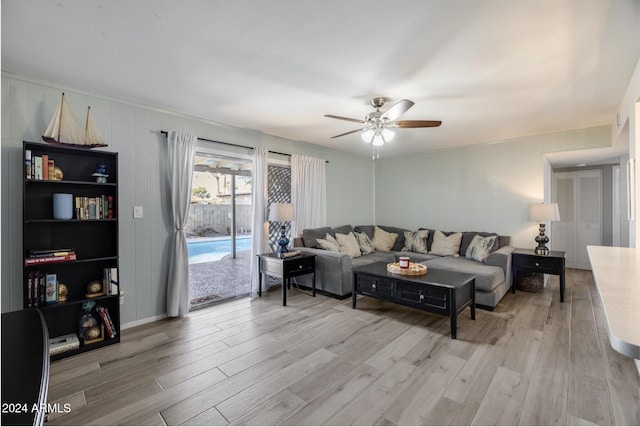 living room featuring light hardwood / wood-style floors and ceiling fan