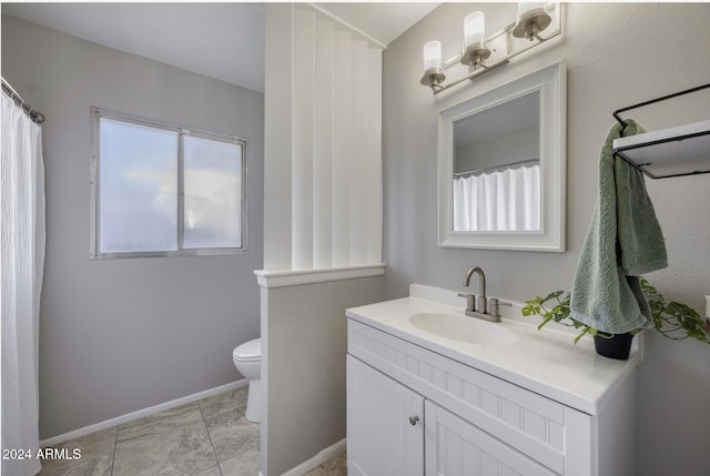 bathroom featuring vanity and toilet