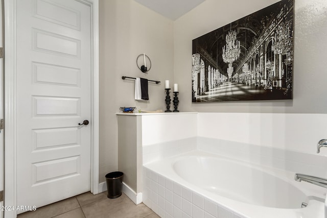 bathroom with tiled bath and tile patterned floors