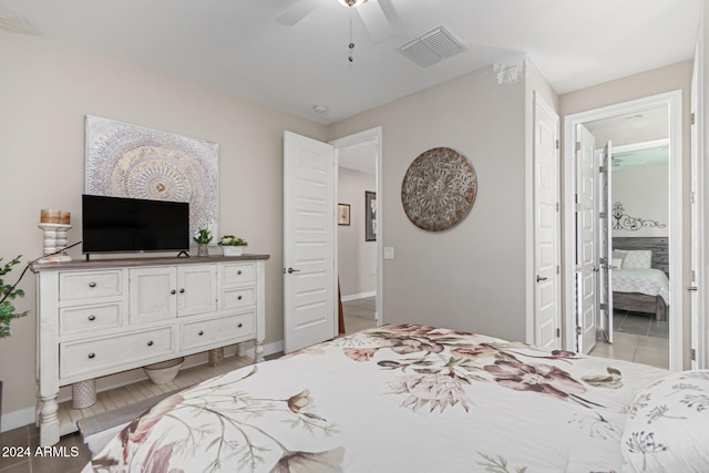 bedroom with ceiling fan and connected bathroom