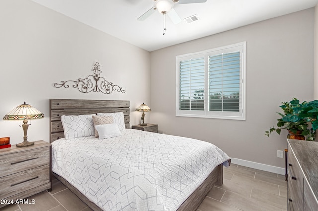 bedroom featuring ceiling fan and dark tile patterned floors