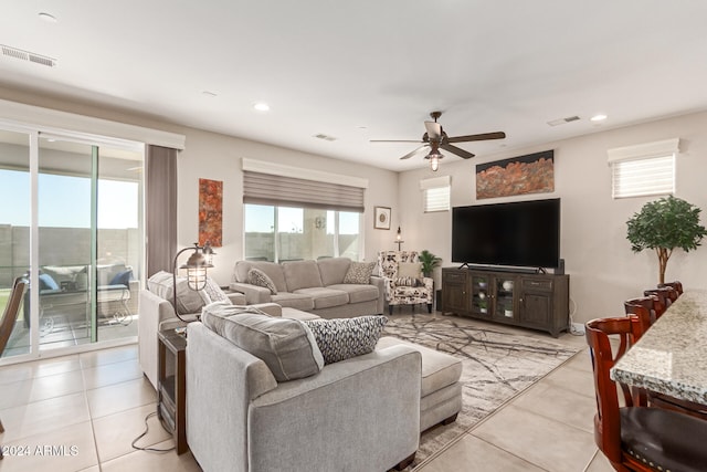 tiled living room featuring a wealth of natural light and ceiling fan