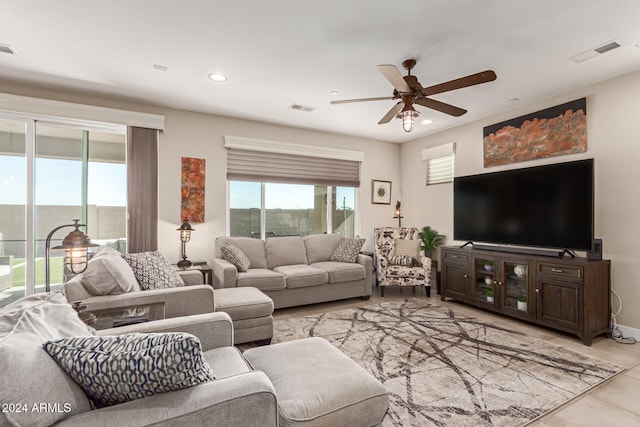 tiled living room featuring ceiling fan