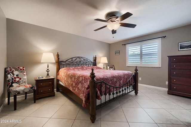 bedroom with ceiling fan and light tile patterned floors