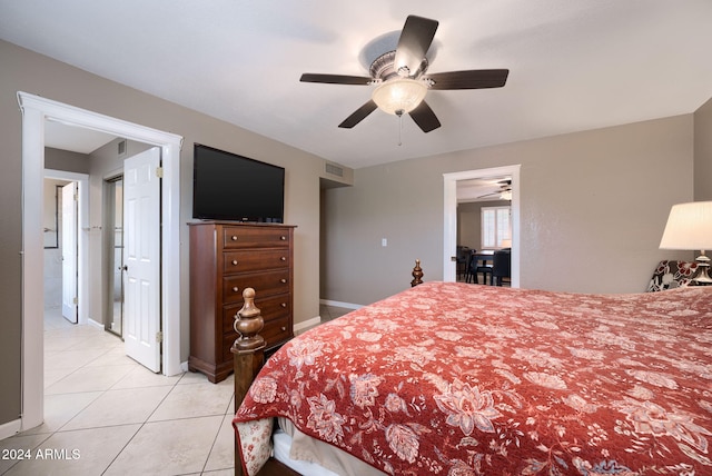 tiled bedroom featuring ceiling fan