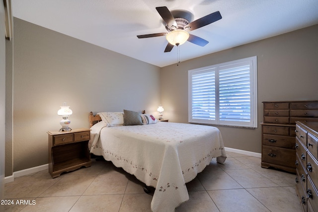 tiled bedroom with ceiling fan