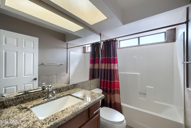 full bathroom with vanity, shower / bathtub combination with curtain, and toilet