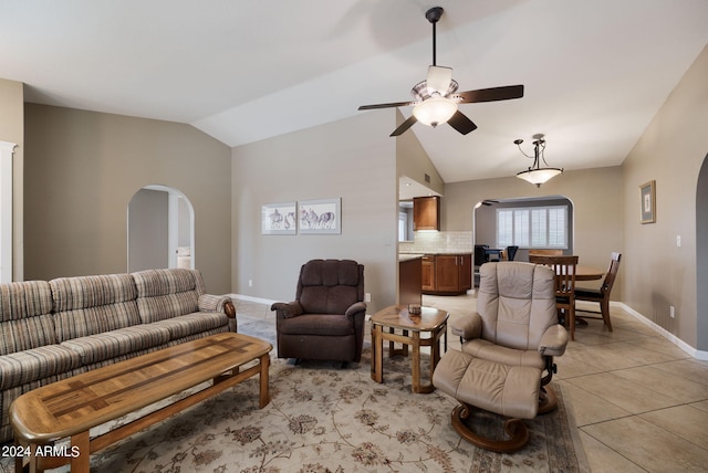 tiled living room featuring ceiling fan and vaulted ceiling