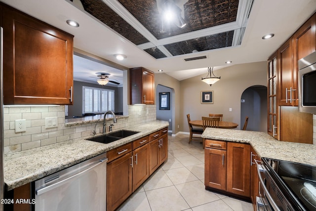 kitchen with appliances with stainless steel finishes, sink, light stone counters, pendant lighting, and ceiling fan