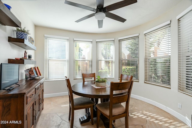 dining room featuring ceiling fan and baseboards