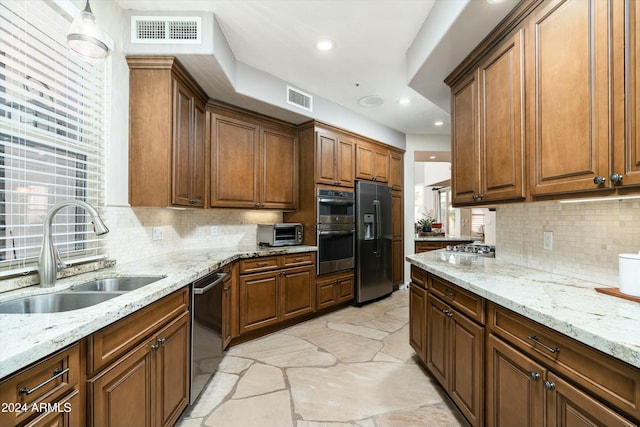 kitchen with appliances with stainless steel finishes, a sink, visible vents, and a toaster