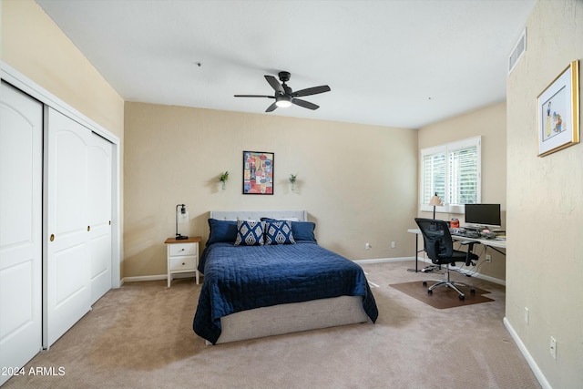 carpeted bedroom featuring ceiling fan, a closet, visible vents, and baseboards