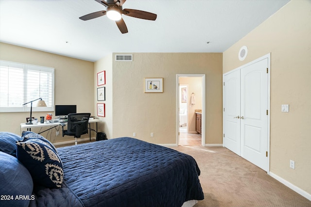 bedroom with light colored carpet, visible vents, a ceiling fan, connected bathroom, and baseboards