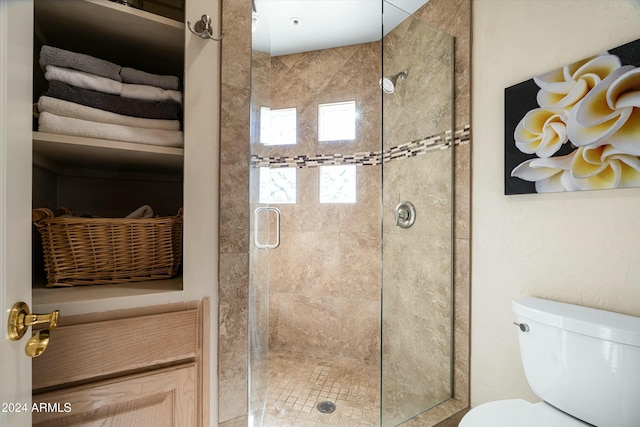 bathroom with toilet and a shower stall