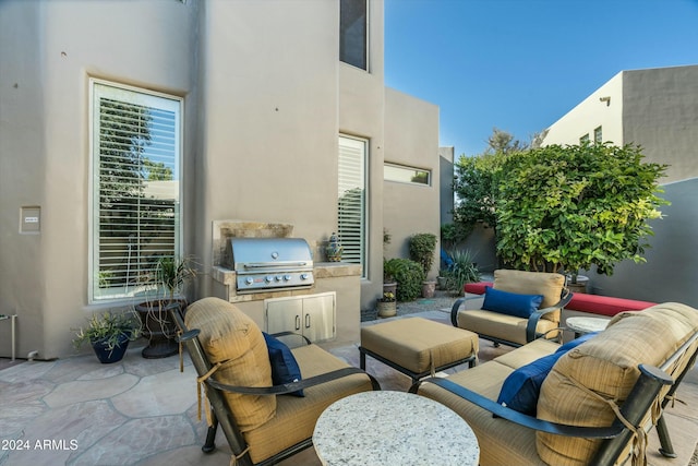 view of patio featuring an outdoor kitchen, a grill, and an outdoor living space