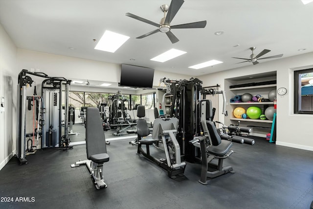 exercise room featuring ceiling fan and baseboards