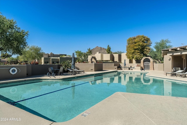 pool featuring a patio and fence