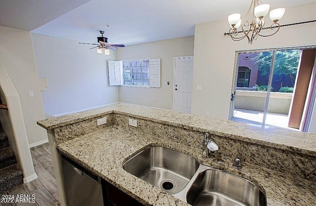 3935 E Rough Rider Rd Unit 1101, Phoenix, AZ 85050 - kitchen featuring stainless steel dishwasher, light stone countertops, wood finished floors, a chandelier, and ceiling fan
