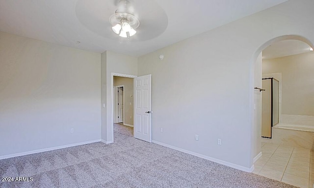 3935 E Rough Rider Rd Unit 1101, Phoenix, AZ 85050 - spare room featuring arched walkways, a ceiling fan, and light colored carpet