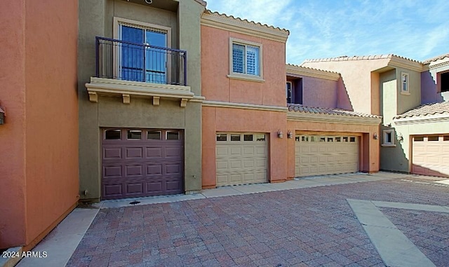 3935 E Rough Rider Rd Unit 1101, Phoenix, AZ 85050 - view of front of house with a tiled roof, stucco siding, and a garage