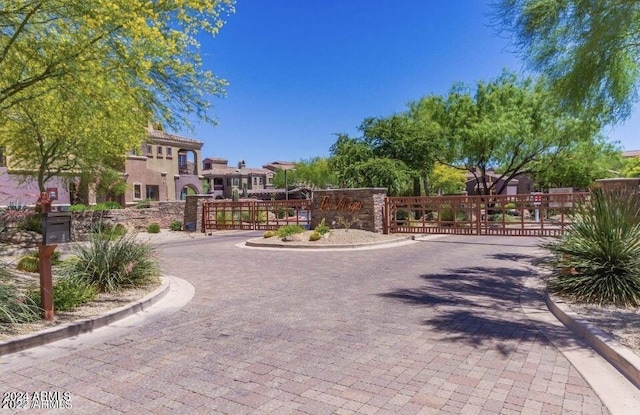 3935 E Rough Rider Rd Unit 1101, Phoenix, AZ 85050 - view of street featuring curbs, a gate, and a gated entry