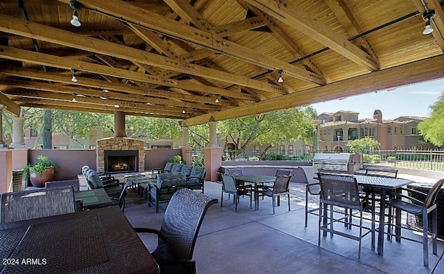 3935 E Rough Rider Rd Unit 1101, Phoenix, AZ 85050 - view of patio / terrace with an outdoor living space with a fireplace, outdoor dining space, and grilling area