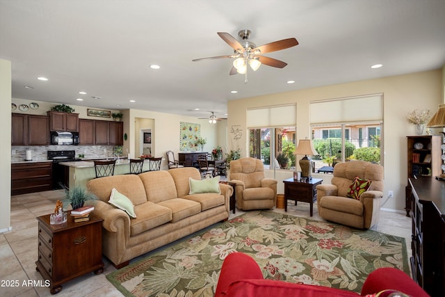 living room with light tile patterned floors, a ceiling fan, and recessed lighting
