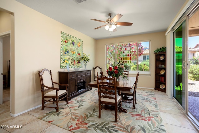dining room with baseboards, ceiling fan, light tile patterned floors, and visible vents