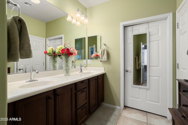 full bathroom featuring a sink, tile patterned floors, double vanity, and visible vents