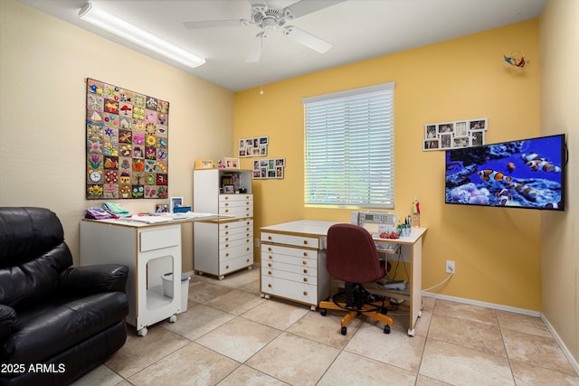 home office featuring baseboards, ceiling fan, and light tile patterned floors