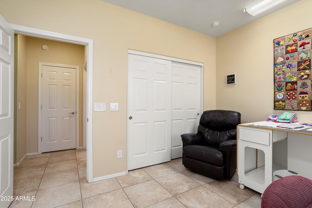 living area with light tile patterned floors and baseboards