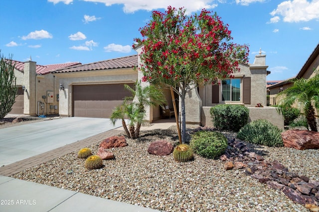 view of front facade featuring a garage, stucco siding, driveway, and a tile roof